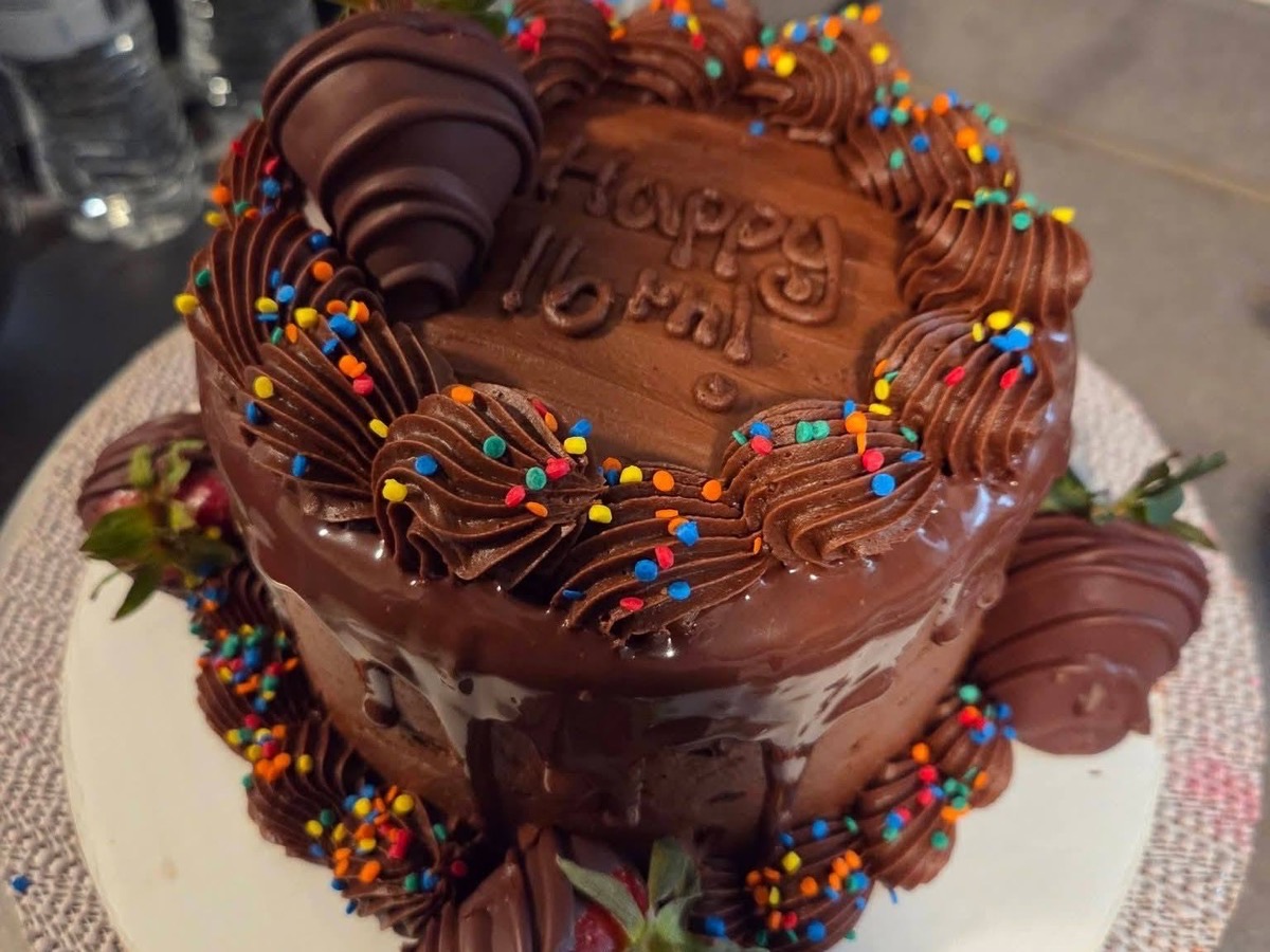 Chocolate drip birthday cake with a rainbow sprinkle border