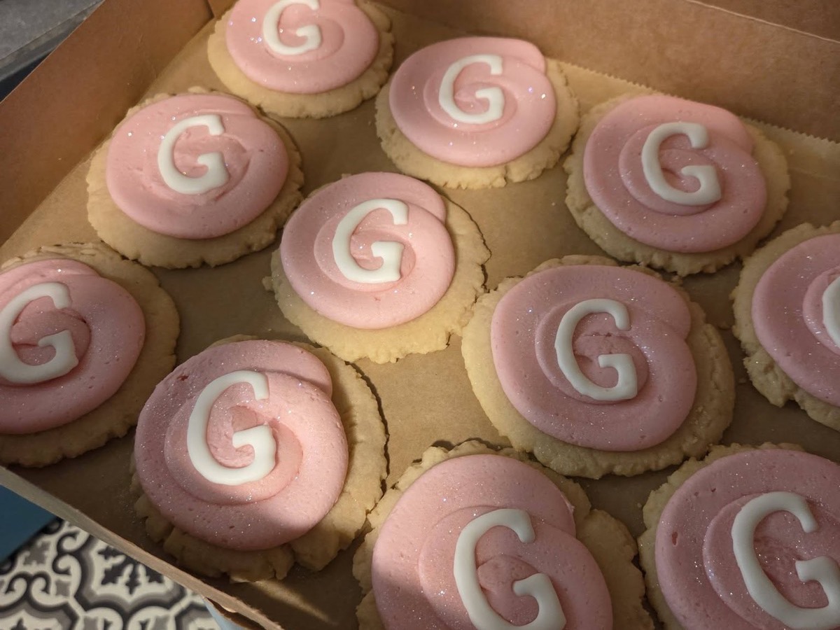 Pink frosted sugar cookies decorated with the letter G