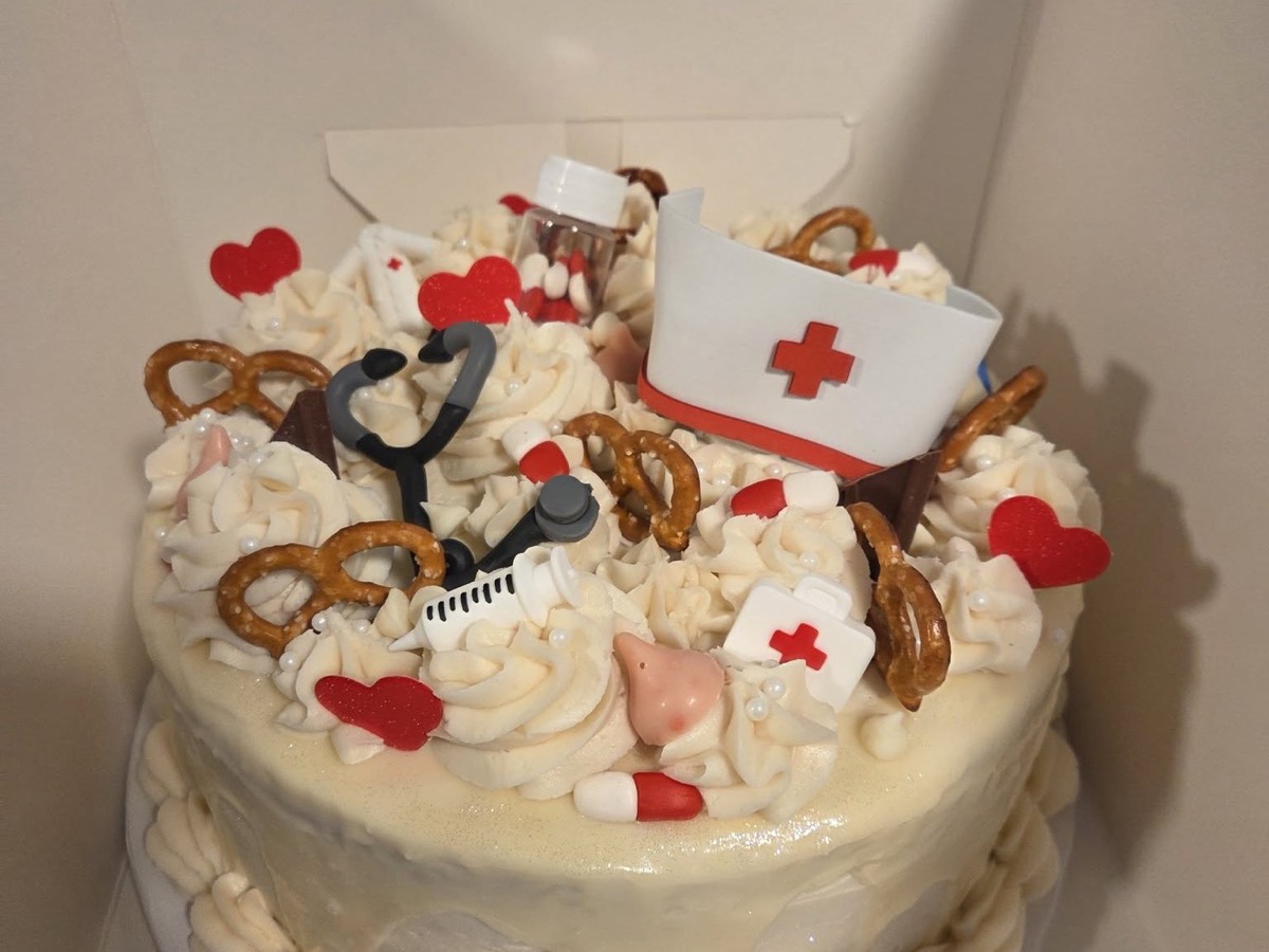 Nurse-themed cake decorated with a stethoscope and nurse cap