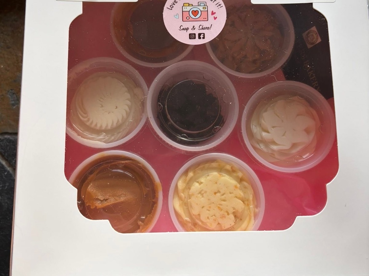 Small cups of caramel, chocolate, and cream cheese frosting